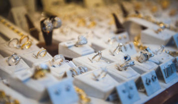 Various silver and golden rings are on display in a jewelry store