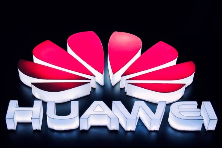 Finance Brokerage-Huawei: undershot of lit up Huawei logo on dark background 