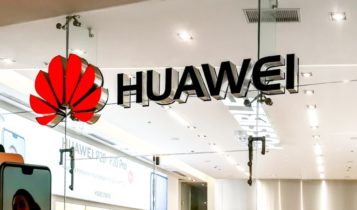 Finance Brokerage-Huawei: Outside shot of Huawei office with a smartphone on the side