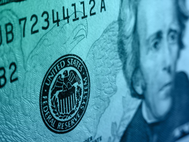The Federal Reserve – close-up of a dollar bill showing the Federal Reserve logo - Finance Brokerage 