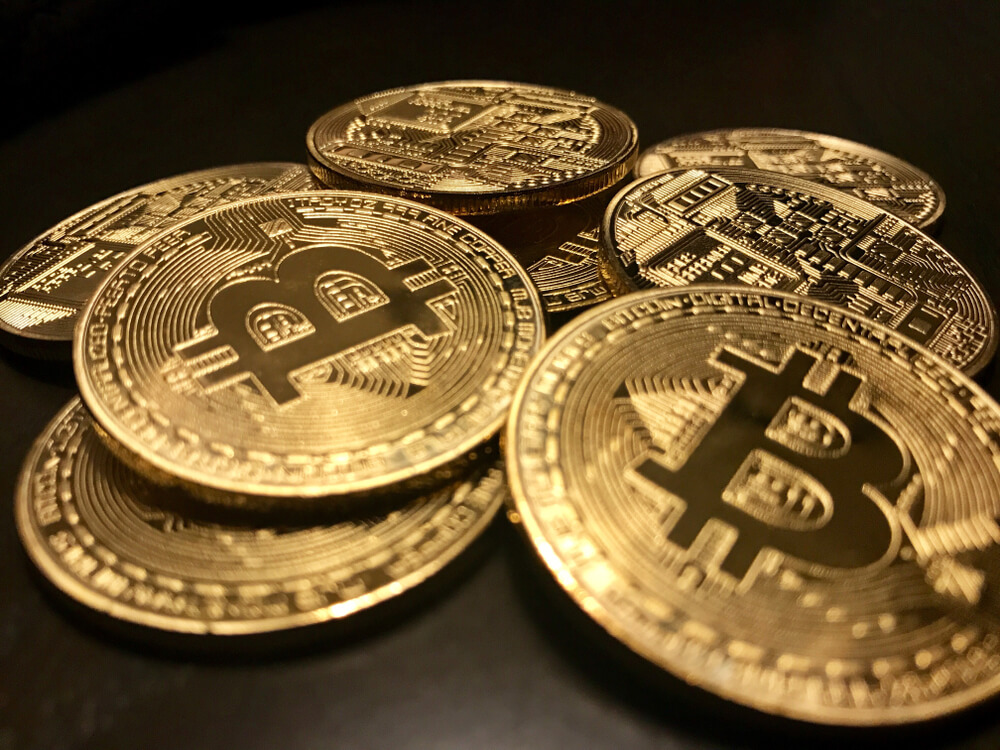Closeup of a pile of Bitcoin coins gold.