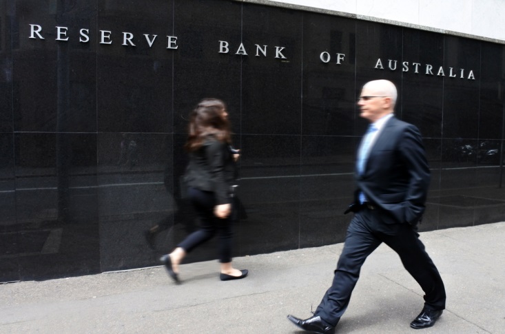 Finance Brokerage – man and woman walking in front of the Reserve Bank of Australia 