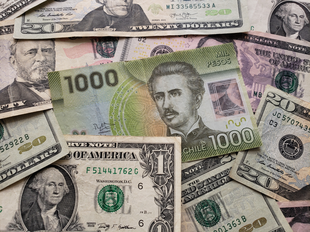 Santiago: chilean banknote of 1000 pesos and american dollars bills.