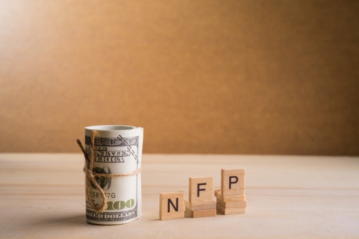 jobs report NFP written on blocks beside dollar – Finance Brokerage 