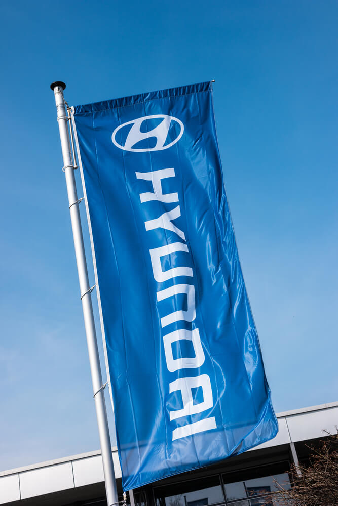 Hyundai Motors: Hyundai flag against blue sky.