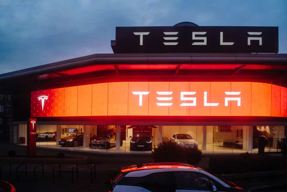 Tesla Motors showroom with multiple luxury Tesla cars inside.